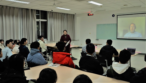 A group of people in a room Description automatically generated with low confidence